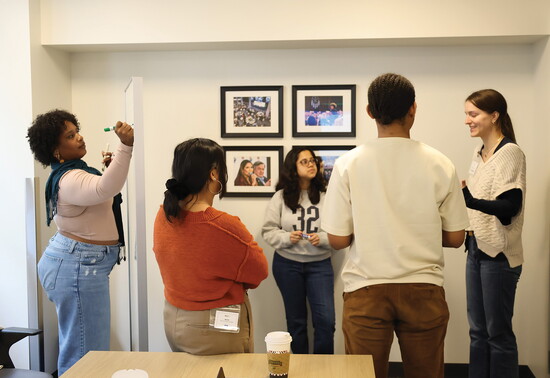 The winning Creative Justice Lab team works together during a brainstorming session in March 2026.