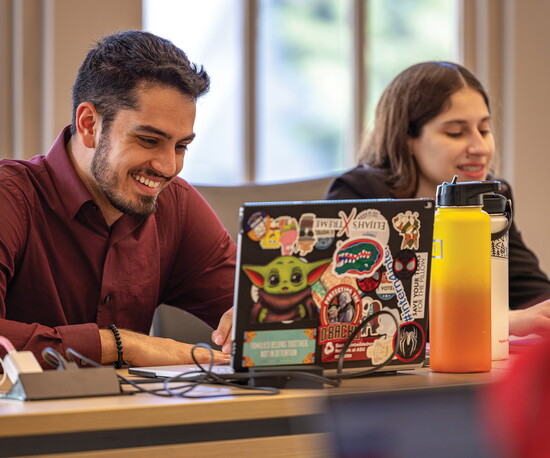 Women’s Power and Influence Index students Tushar Saraswat (left) and Molly Mashal (right) work on a task.