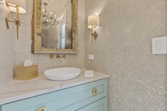 An over the top beautiful formal powder room where elegant materials – some old some new – function as friendly for pool guests.