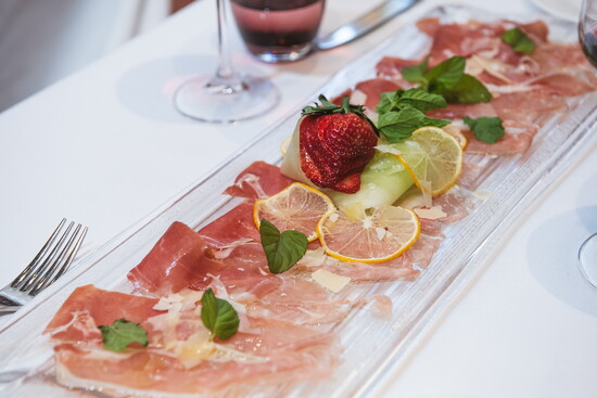 30-month aged prosciutto served with melon, mint salad, and lemon