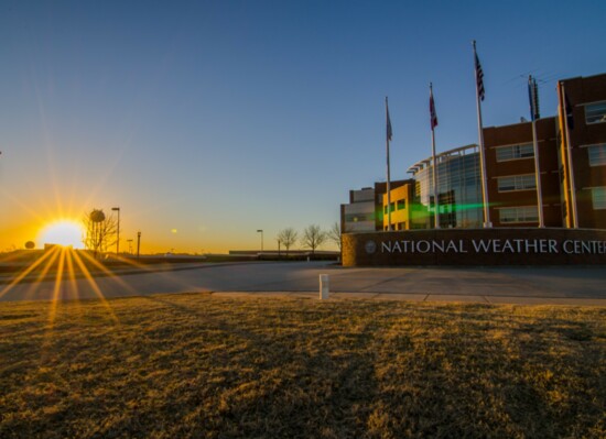 The sun rises behind the National Weather Center at OU (Photography Jim Kurdzo)