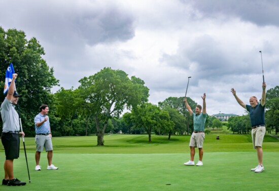Golfers celebrate a putt on Bluegrass Yacht & Country Club's championship 18-hole course.