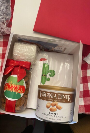 Custom gift box. Assorted items including tea towel and cookies . Contact them for pricing