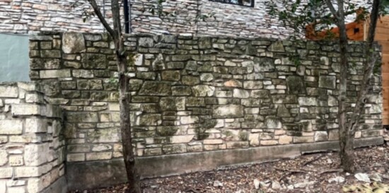 Rock wall before Rolling Suds power washing. 