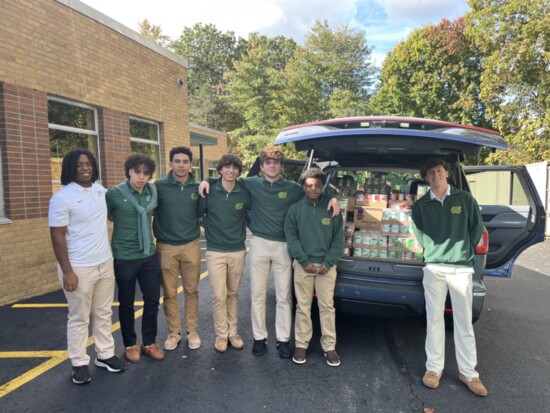 Green Knights helping load canned goods.