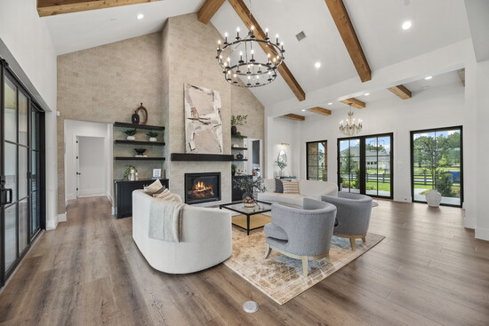 The great room brings vaulted beams, natural light and open sightlines together in a warm, welcoming space designed for gathering.
