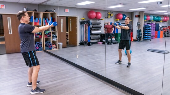 Jeff Stine works out under the watchful eyes of personal trainer Andrew Murray.
