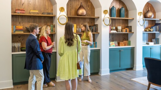 Owner Challie Knetter, in green top, speaks to guests.