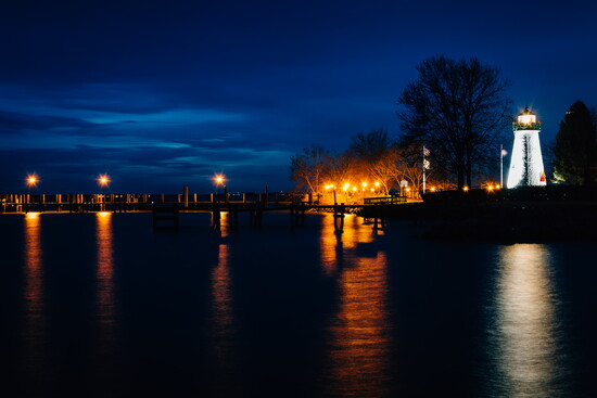 Concord Point Lighhouse and a pier at night. 
