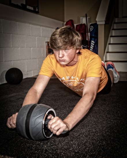 Jojo Crump works on his core strength with an exercise roller.