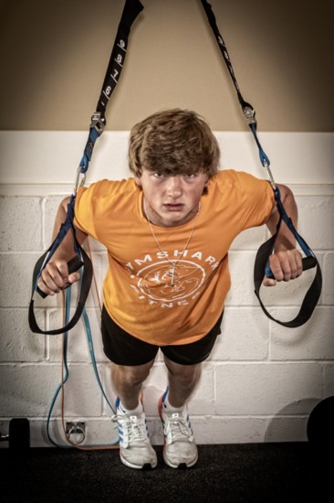 Jojo Crump strengthens his upper body with exercise stirrups.