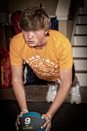 Jojo Crump works on his core strength with a medicine ball.