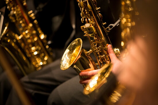 A saxophone’s curves catch the light, ready to speak in rich tones.