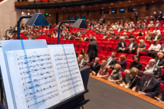 The theater fills as quiet anticipation settles before the first note.