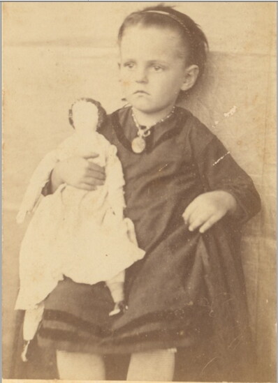 Lillie Pierce, age 4, with her doll Nellie—brought from Key West by her uncle, who salvaged brass and copper from shipwrecks, sailed two weeks to trade it for t