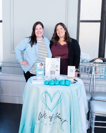 Kara Kushnir alongside her sister Kristen Delventhal at A Work of Heart Counseling table.