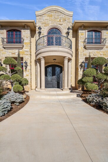 An entryway becomes dramatic with the use of cast stone.