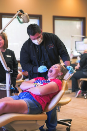 Open up! Dr. Streight checks out a young patient's braces. PHOTO BY RYAN LASSITER, DEFINING IMAGE