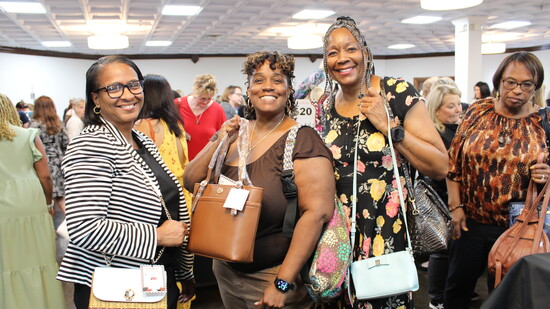 Attendees of the 2025 Power of the Purse event showcasing their curated selections