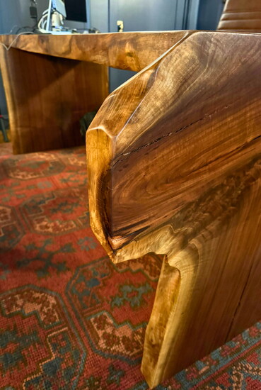 Live edge of a hand-carved desk inside consultation room at Vitality Orthopedics
