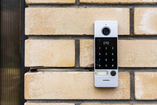 Camera and intercom on the front of a home.