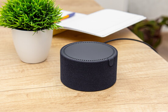 Smart speaker on a wooden table.