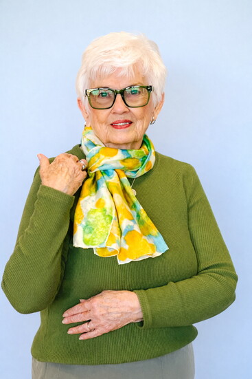 Lois, a longtime customer, has a scarf around her neck for a  classic spring look.