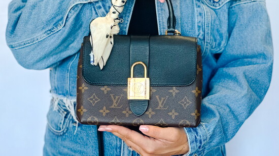 Stephanie is holding Louis Vuitton handbag styled with a silk scarf around the handle to add a pop.