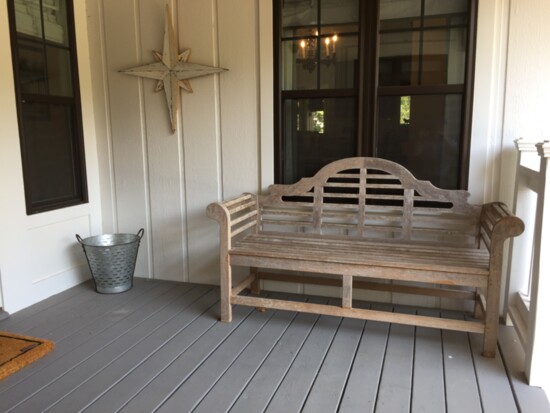 This teak bench adds character to this outdoor living space.