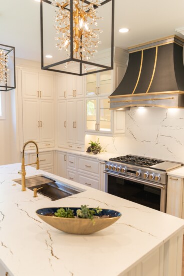 Gold accents bring tremendous warmth to this total kitchen remodel.