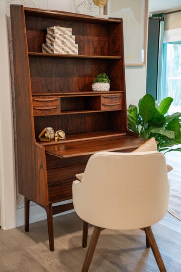 The vintage Danish mid-century modern rosewood secretary desk is the highlight of the space, a stunning collectible that the family will pass down.