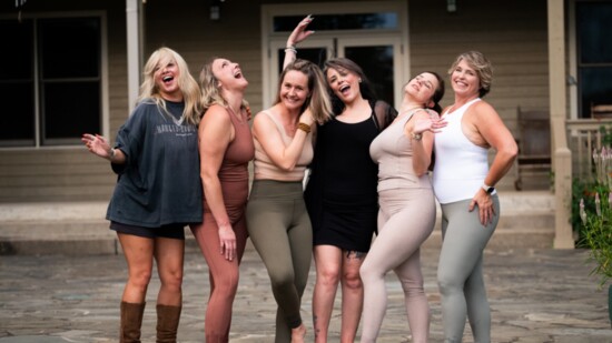 Lindsey Felton (left) and Karesten Porter (third from right) after a recent photo shoot for YogaSix.
