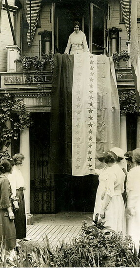 Alice Paul unfurling "Ratification Banner" from the National Woman’s Party headquarters, Washington, D.C., August 18, 1920. Library of Congress
