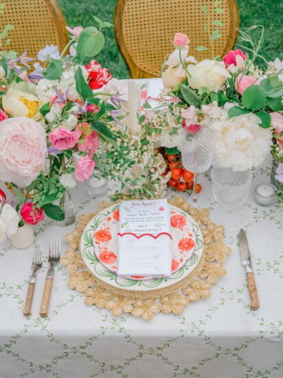 The layering of the patterns of multiple dishes atop a rattan placemat and custom linen helped to build the depth of the table.