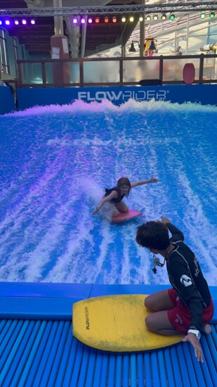 The publishers' daughter, Charlotte, riding the waves on the FlowRider