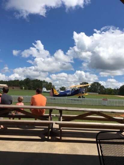 Right: Folks gather at Barnstormer's Grill to watch vintage planes.