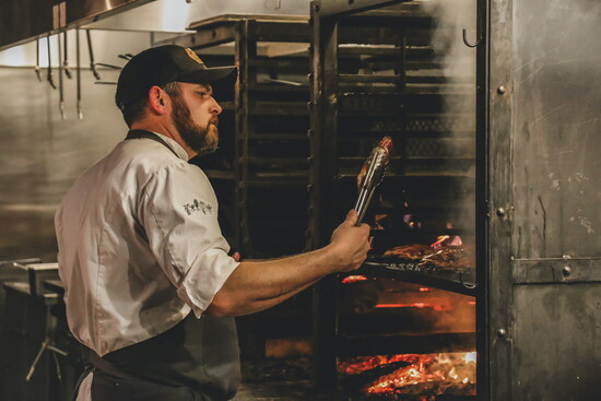 Chef Rule at the custom-built wood burning hearth