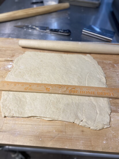 Rolling out of of the six layers of pastry dough before proofing it.