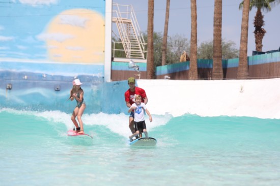Nixon surfing with pro surfer Josh Kerr and his daughter, pro surfer/pro skateboarder Sierra Kerr.