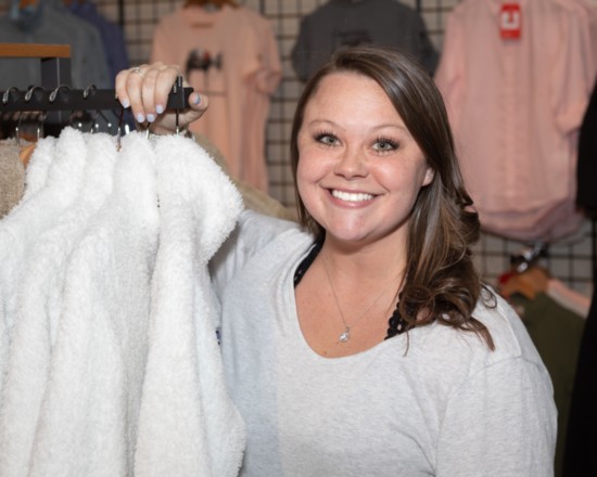 Store Manager Makenzie Collier shows off some new outerwear.