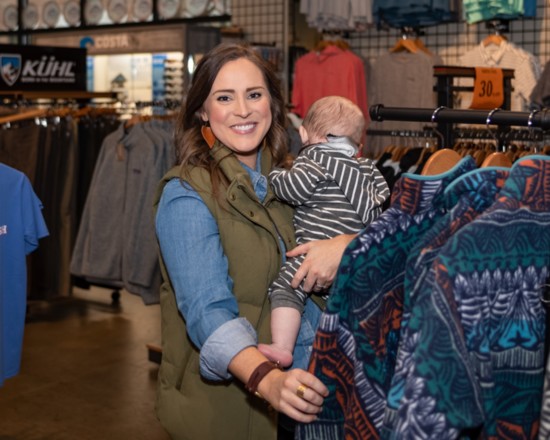 Bink's Buyer/Manager Emily Britton checks out new clothing additions with her son, Rudy.