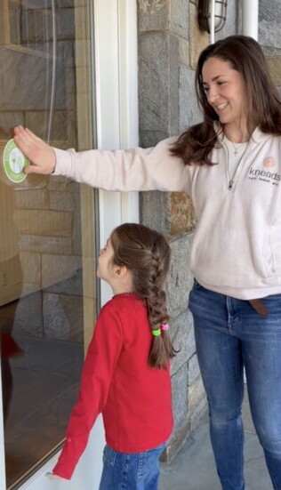 Brittany Moreno with the "Sustainable Westport Champion" certification outside Kneads.