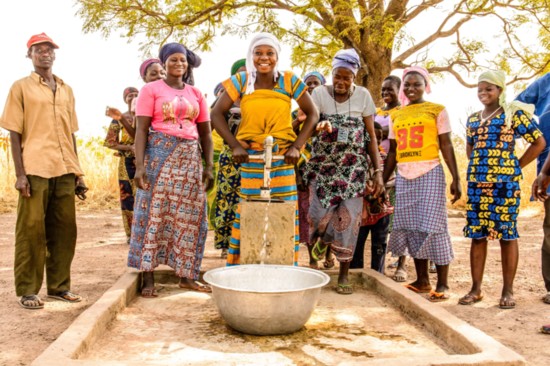 Women in Ghana gather around a well that was provided by Water4.