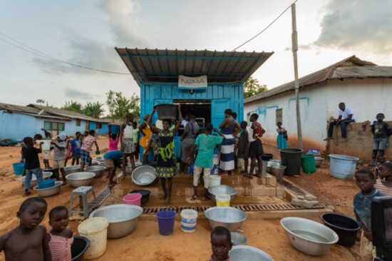 Villagers line up for clean water at a station in Ghana where Water4 works.