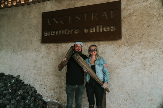 Brian and Sam, owners of Luna’s, hold a mazo—a traditional tool used to crush agave for ancestral mezcal, distilled later in clay pots.