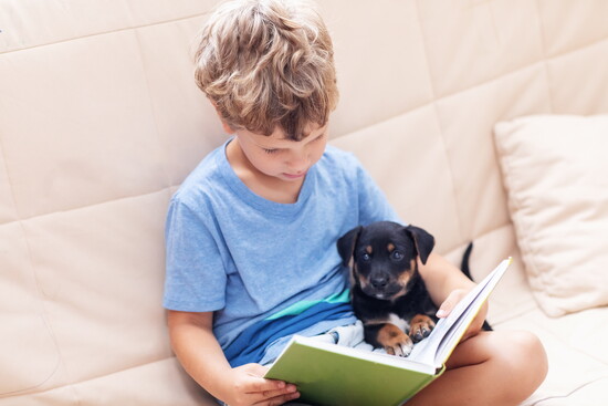 Child reading to a dog. 