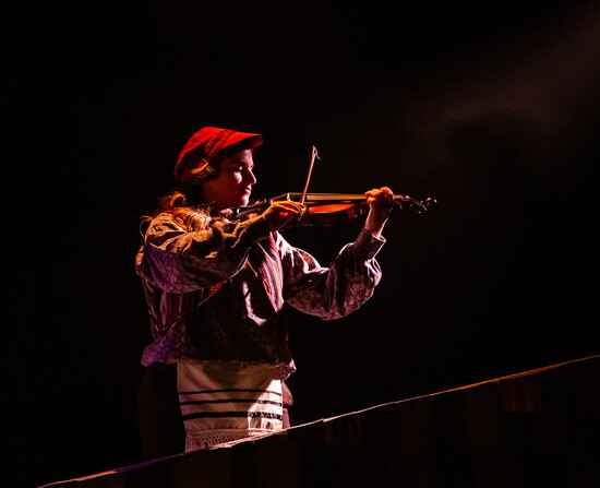 Bre Turner delivers a captivating violin performance in Fiddler on the Roof.