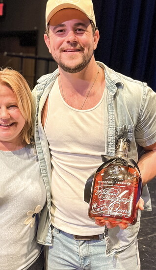 Renee Moore and Matt Jordan and the engraved art bottle from Wrapped and Written