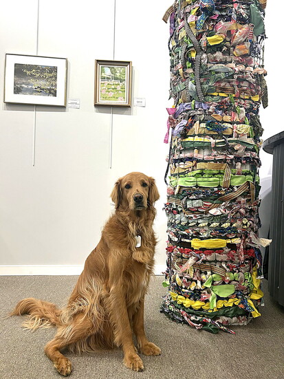 Murray in front of a collaborative community weaving 