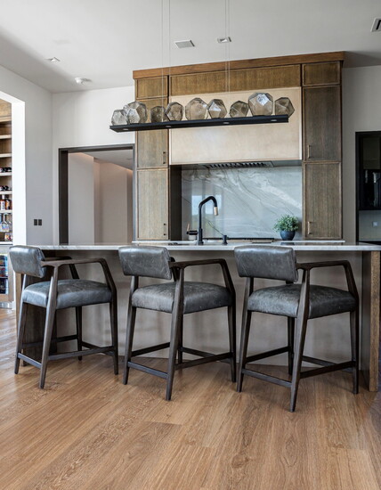 All Quartzite  kitchen surfaces, and backsplash with custom metal range hood